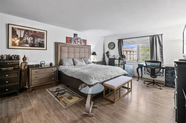 a bedroom with a bed and a television