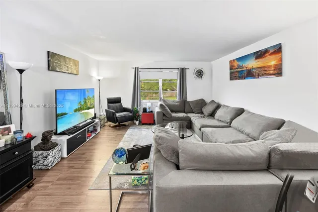 a living room with furniture and a large window