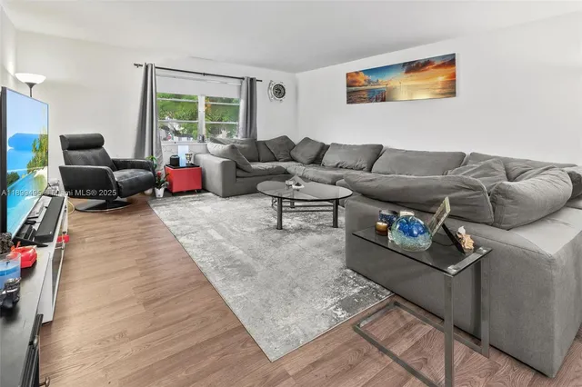 a view of a dining room with furniture wooden floor and a chandelier