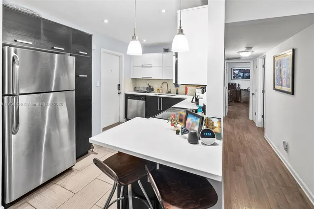 a kitchen with stainless steel appliances a stove sink microwave and cabinets