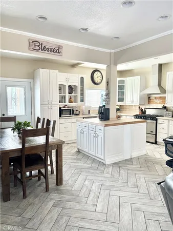 a large kitchen with stainless steel appliances kitchen island granite countertop a sink and cabinets