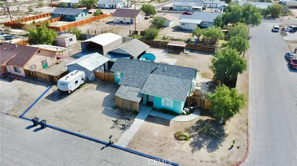 an aerial view of a house with a yard