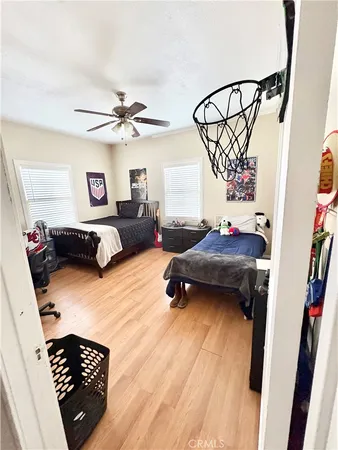 a bedroom with furniture and a wooden floor