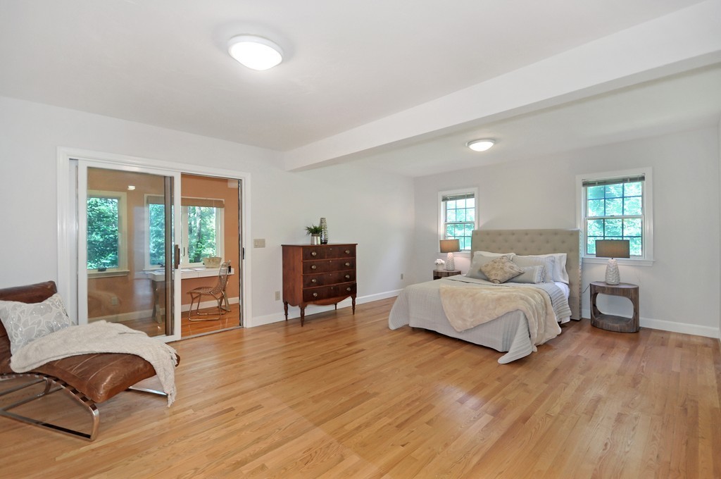 65 College Road Concord, MA 01742 - Photo 9 of 13 a spacious bedroom with a bed and wooden floor