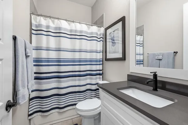 a bathroom with a sink a toilet and a shower