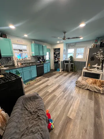 a kitchen with microwave a stove and cabinets