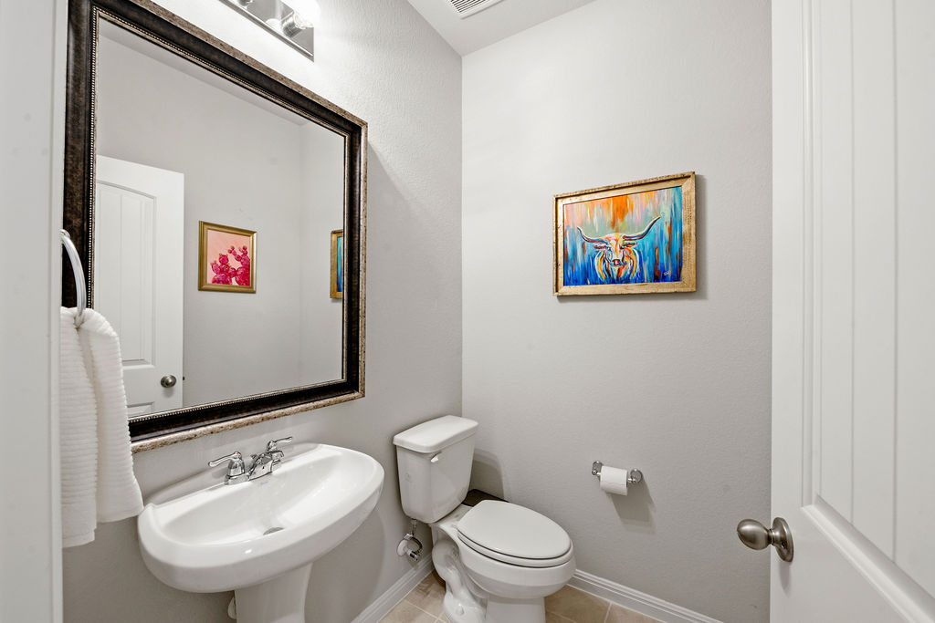 2417 Roosevelt Road Leander, TX 78641 - Photo 22 of 40 Half bathroom with a sink and tile patterned flooring