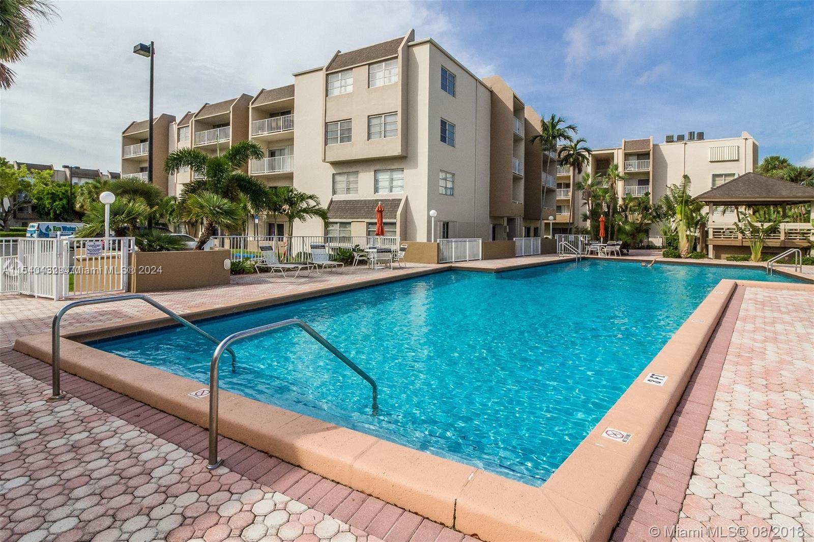 7785 Southwest 86th Street, Unit E116 Miami, FL 33143 - Photo 13 of 27 a view of swimming pool with a chairs