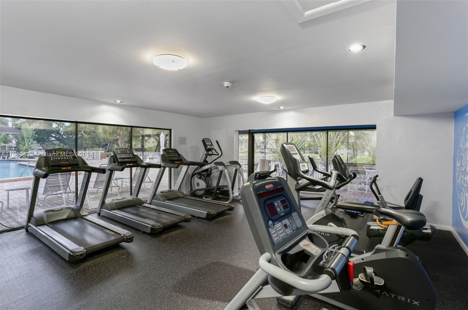 7785 Southwest 86th Street, Unit E116 Miami, FL 33143 - Photo 19 of 27 a view of a room with gym equipment