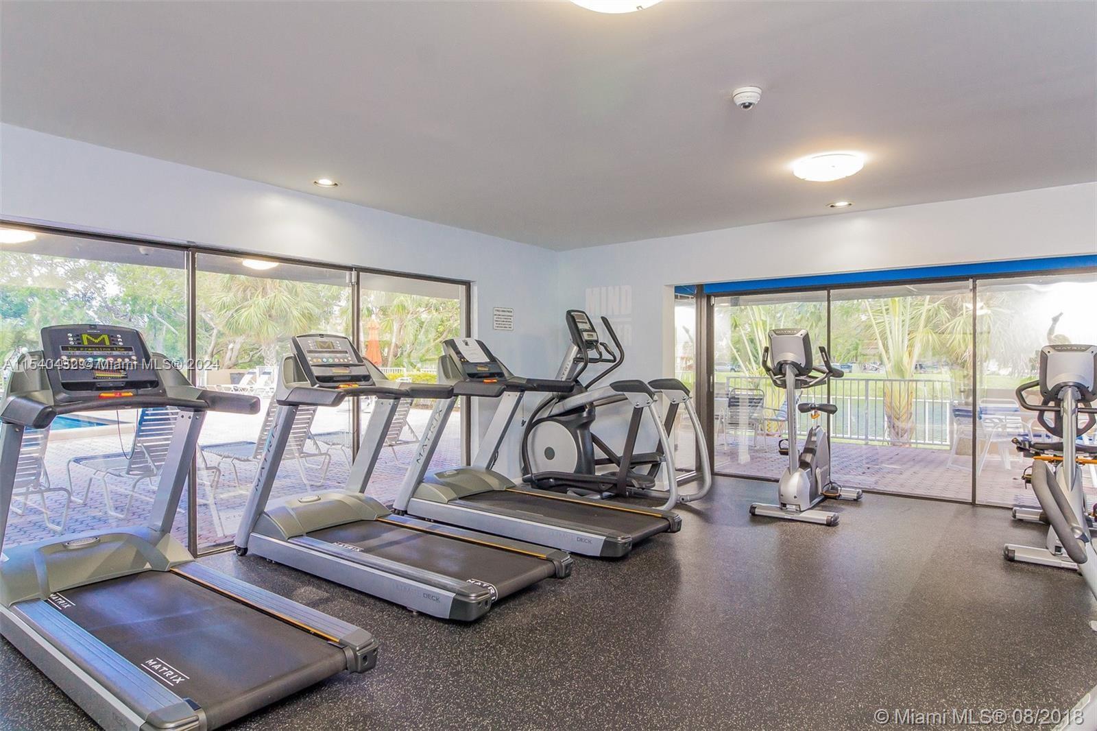 7785 Southwest 86th Street, Unit E116 Miami, FL 33143 - Photo 20 of 27 a view of a room with gym equipment