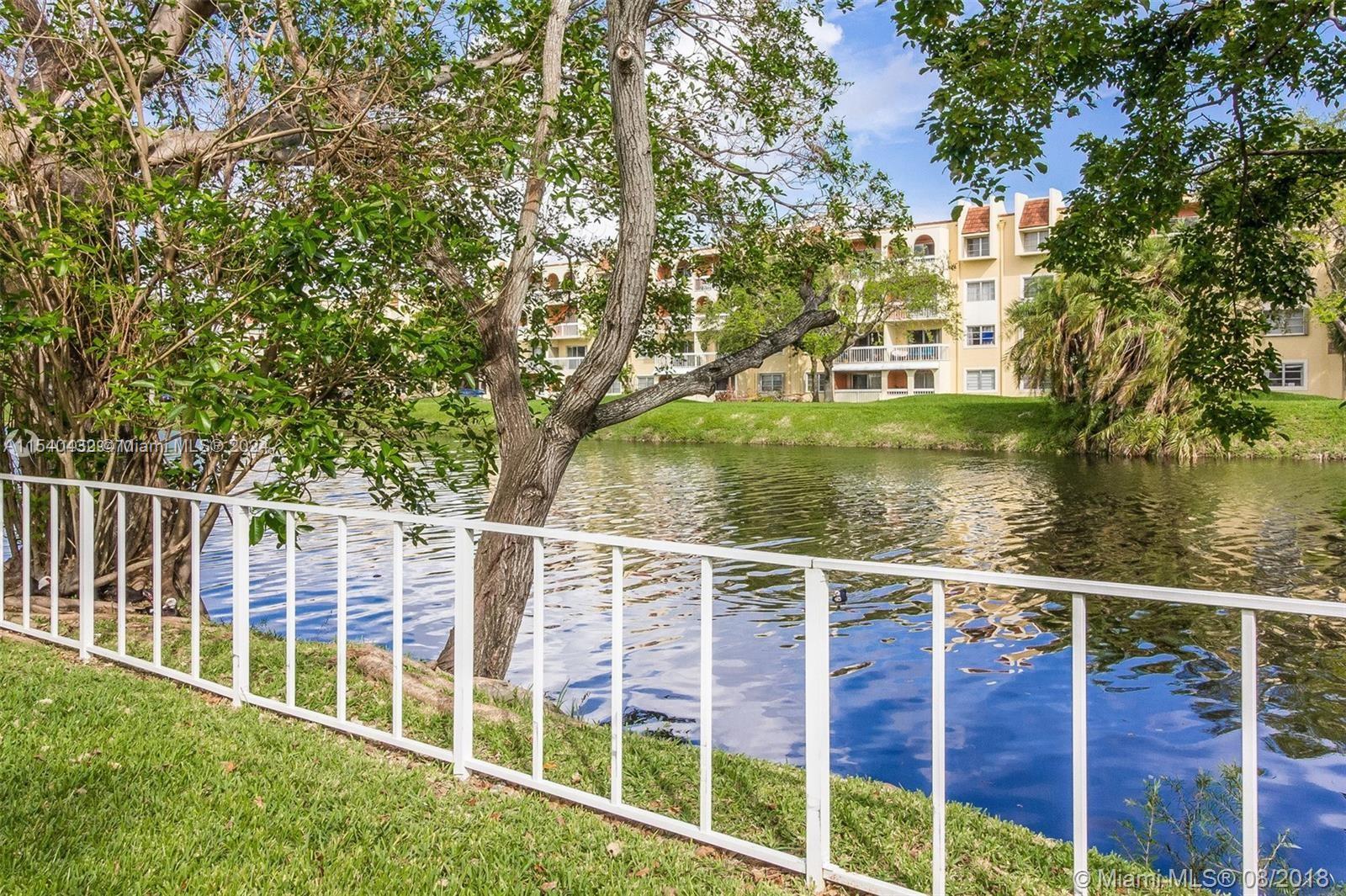 7785 Southwest 86th Street, Unit E116 Miami, FL 33143 - Photo 2 of 27 a view of a yard with large trees