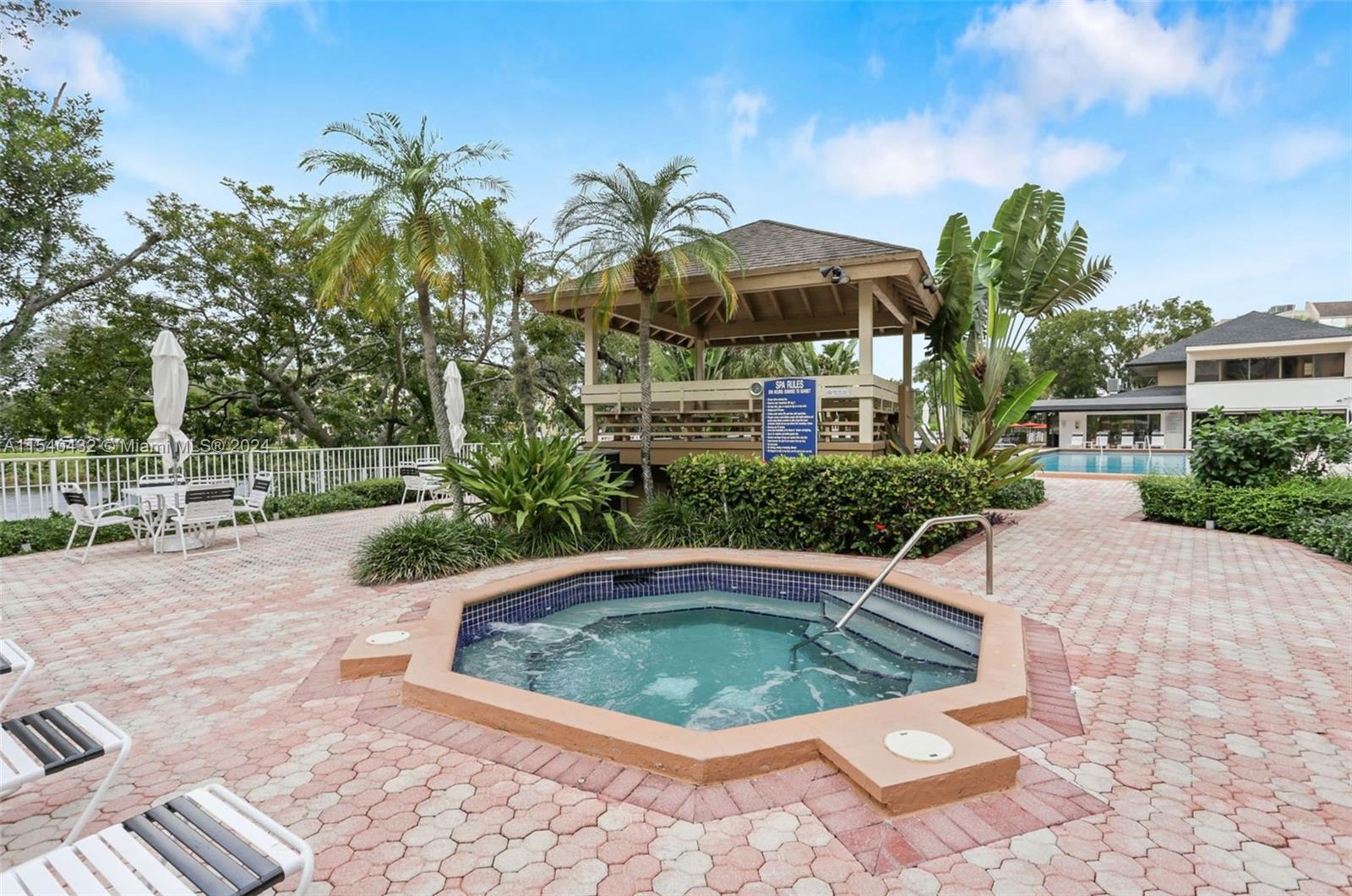 7785 Southwest 86th Street, Unit E116 Miami, FL 33143 - Photo 23 of 27 a view of a swimming pool with a patio