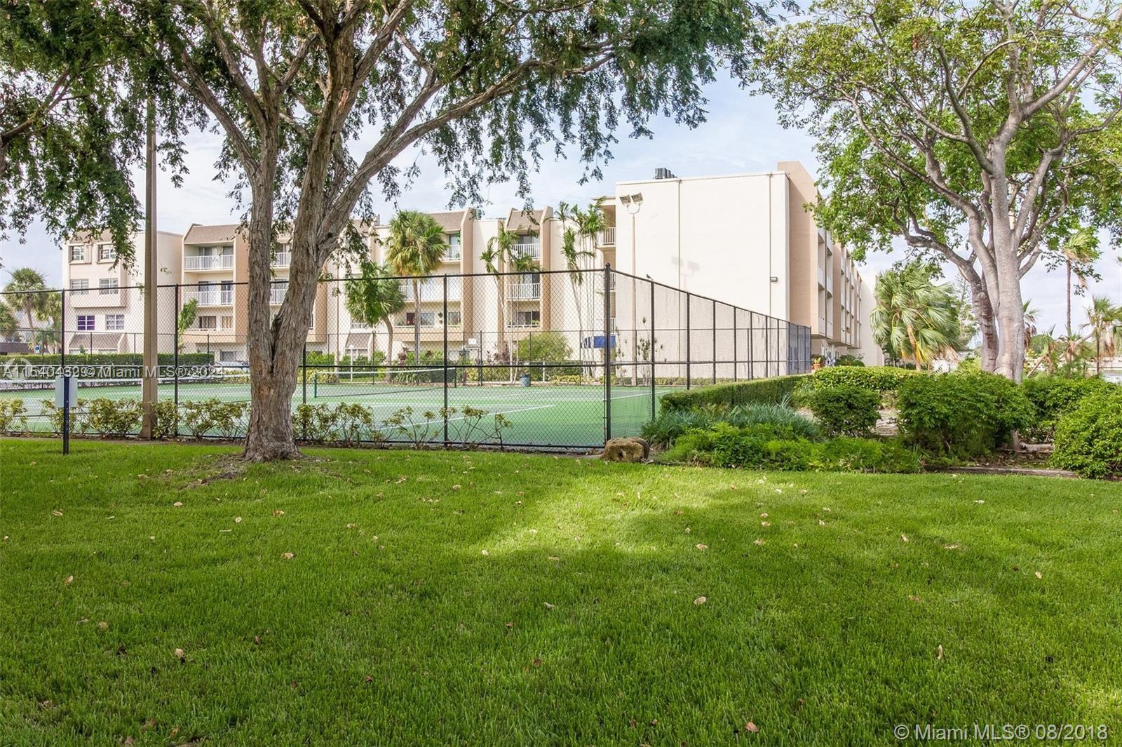 7785 Southwest 86th Street, Unit E116 Miami, FL 33143 - Photo 24 of 27 a view of a garden with a tree