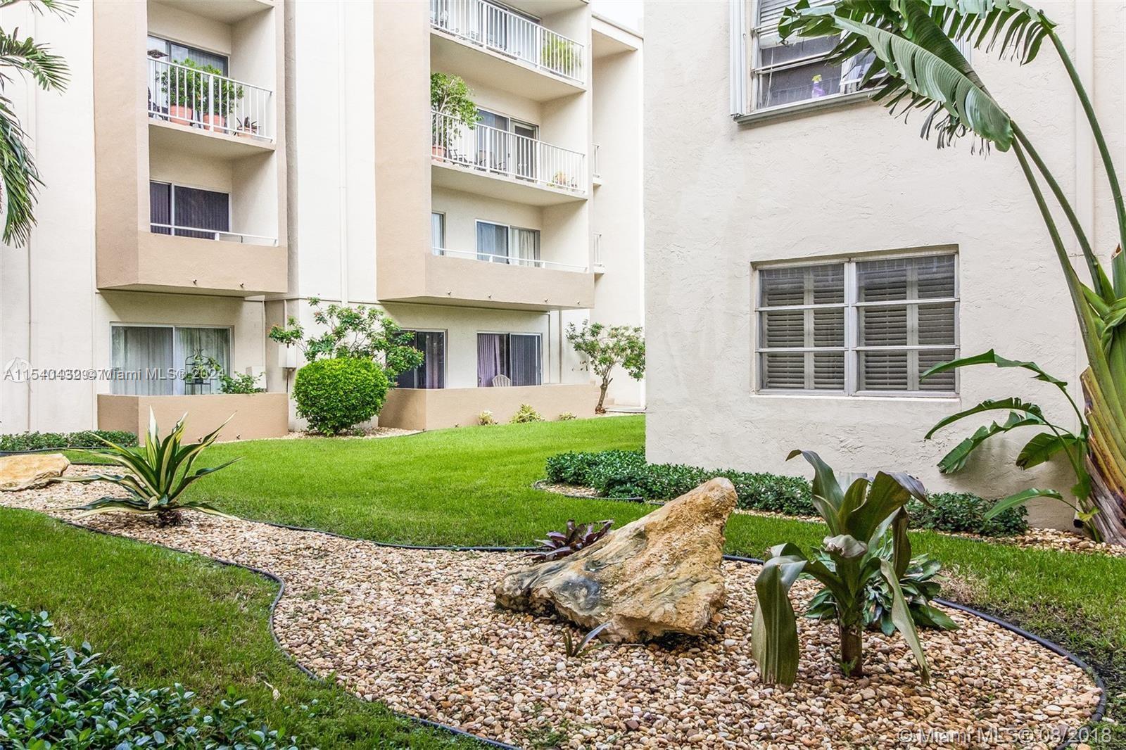 7785 Southwest 86th Street, Unit E116 Miami, FL 33143 - Photo 3 of 27 a house view with a garden space