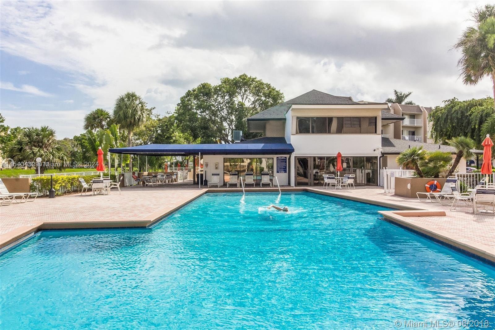 7785 Southwest 86th Street, Unit E116 Miami, FL 33143 - Photo 4 of 27 a view of a house with pool and a yard