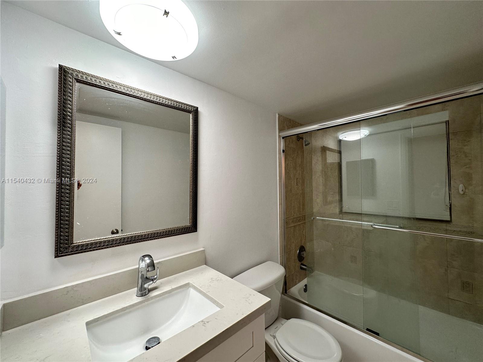 7785 Southwest 86th Street, Unit E116 Miami, FL 33143 - Photo 10 of 27 a bathroom with a sink and a mirror