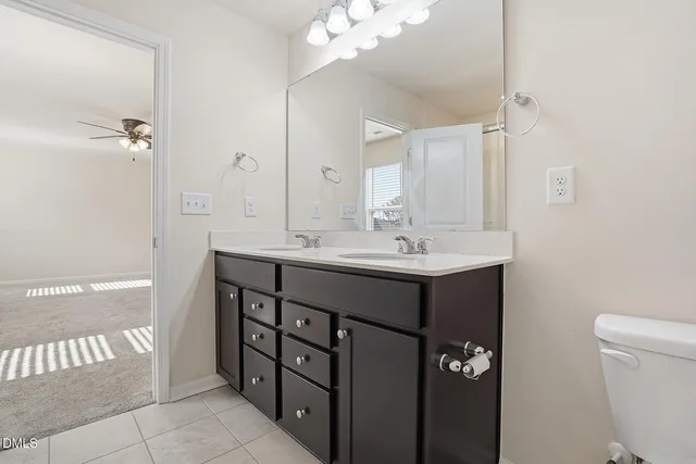 a bathroom with a sink vanity and a mirror