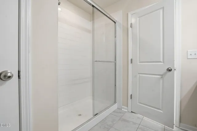 a bathroom with a glass shower door