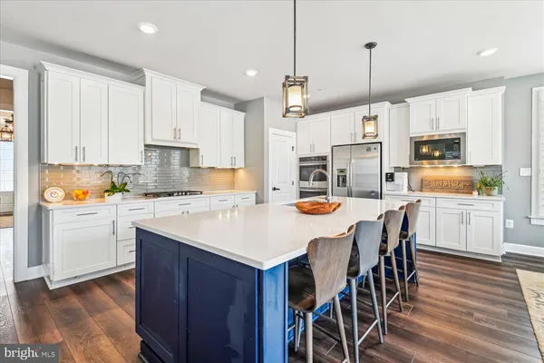 a living room with furniture and view of kitchen