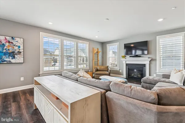 a view of a hallway with wooden floor and entryway