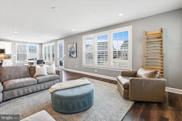 a view of a hallway with wooden floor and windows