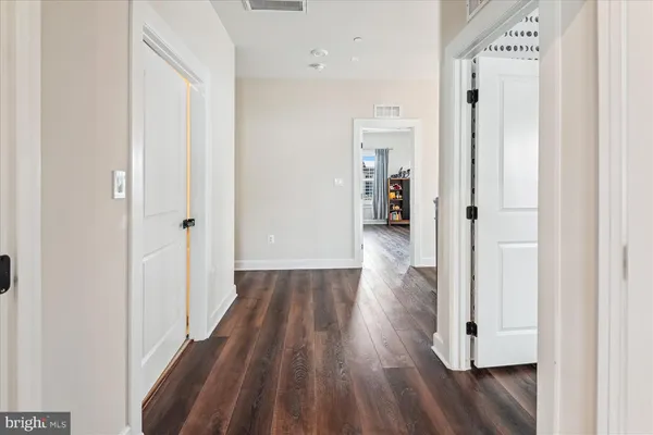 a bathroom with a granite countertop sink and a toilet