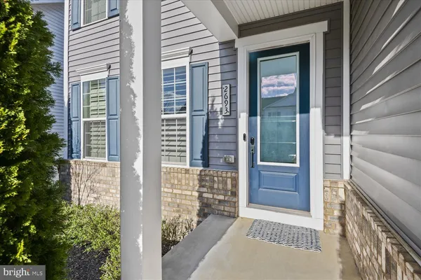 a view of a bedroom with wooden floor and windows