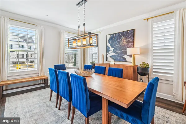 a view of a dining room with furniture large windows and wooden floor