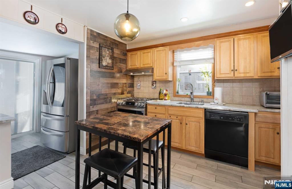 10 Trinity Place Kearny, NJ 07032 - Photo 11 of 30 a kitchen with a table chairs sink and cabinets