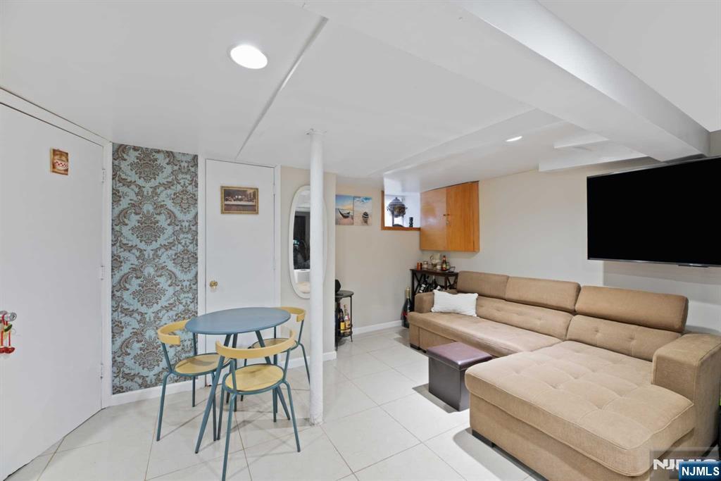 10 Trinity Place Kearny, NJ 07032 - Photo 23 of 30 a living room with furniture and a flat screen tv