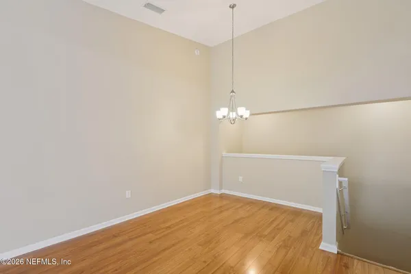 a view of a room with wooden floor