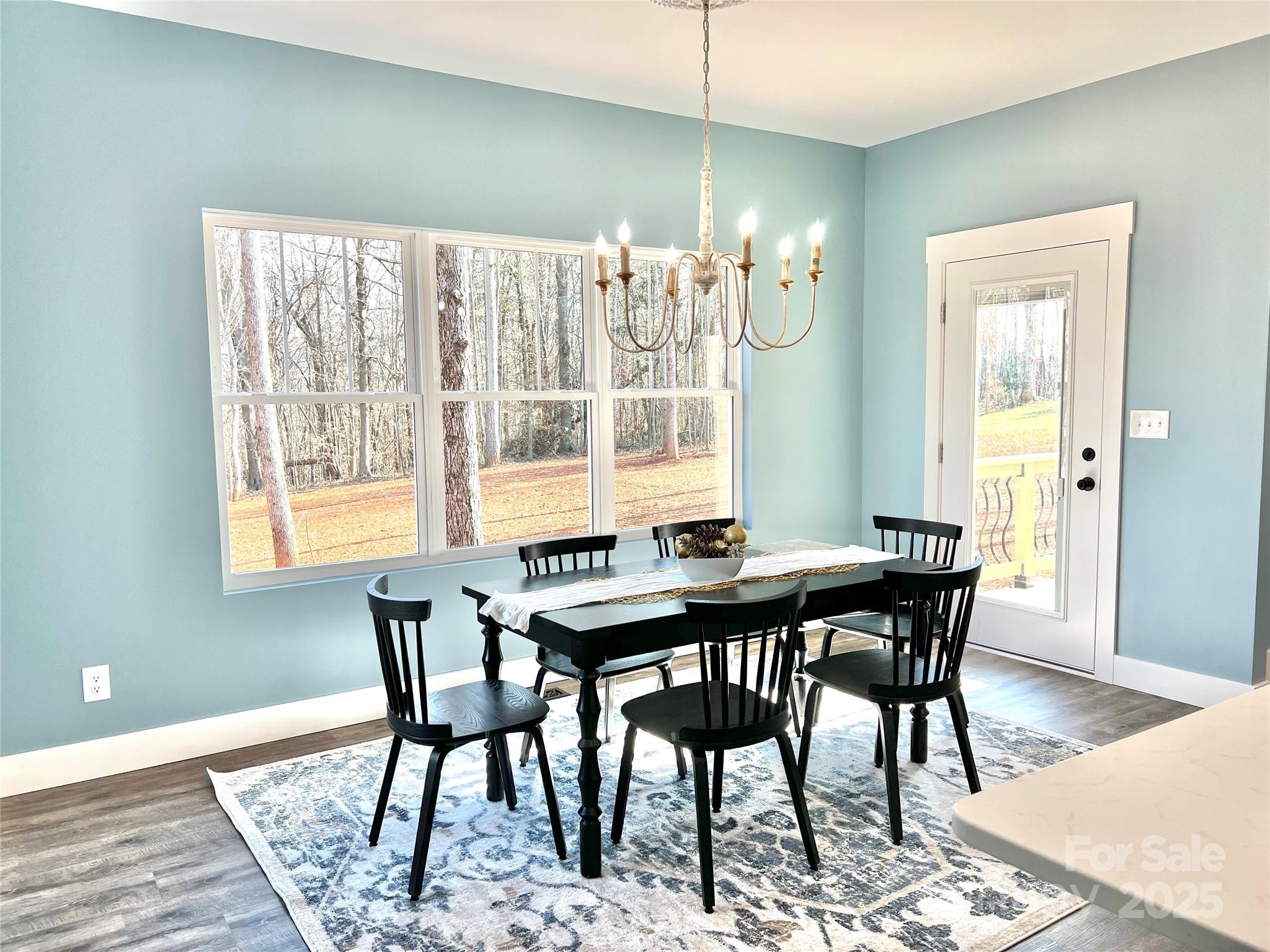 122 Arrowood Lane Harmony, NC 28634 - Photo 13 of 47 a view of a dining room with furniture window and wooden floor
