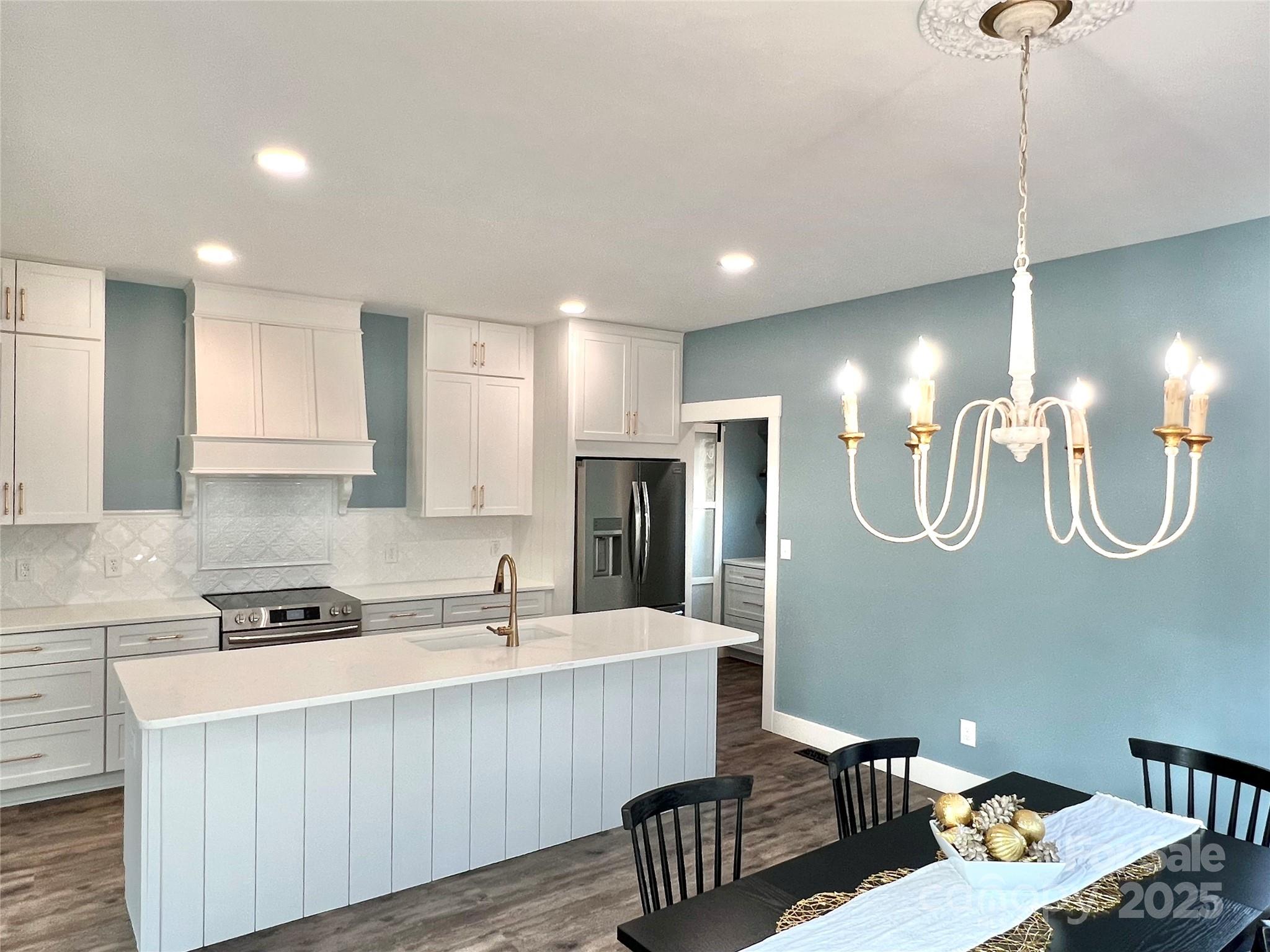 122 Arrowood Lane Harmony, NC 28634 - Photo 14 of 47 a kitchen with a table chairs and a living room view