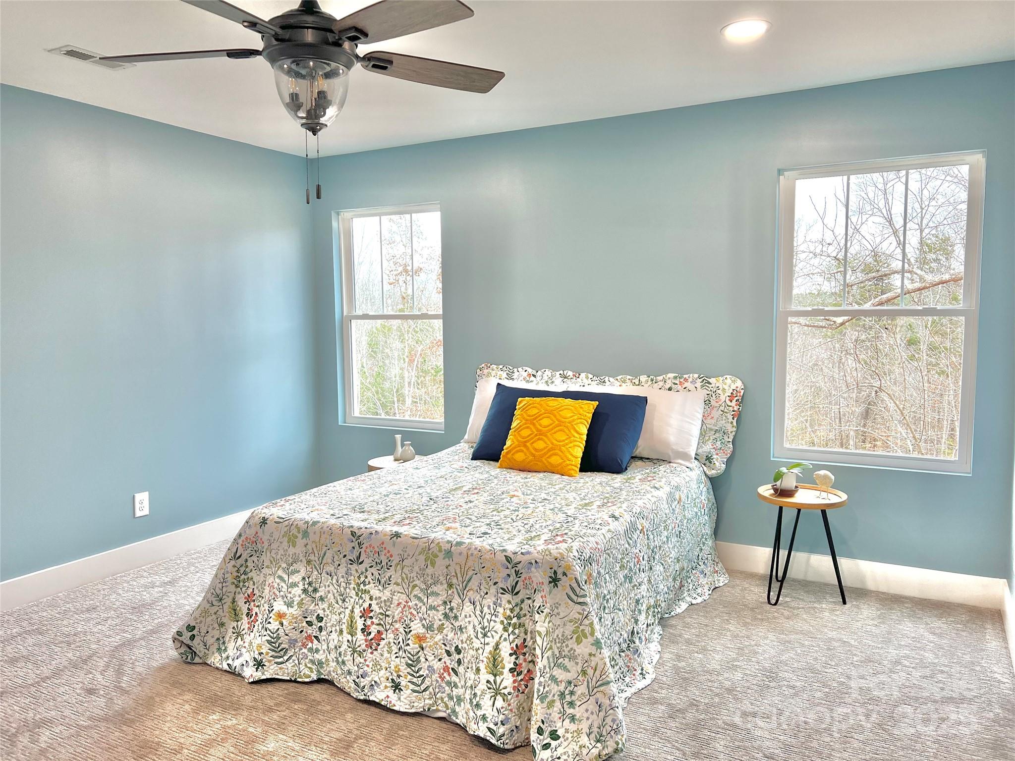122 Arrowood Lane Harmony, NC 28634 - Photo 20 of 47 a bedroom with a bed and a chandelier