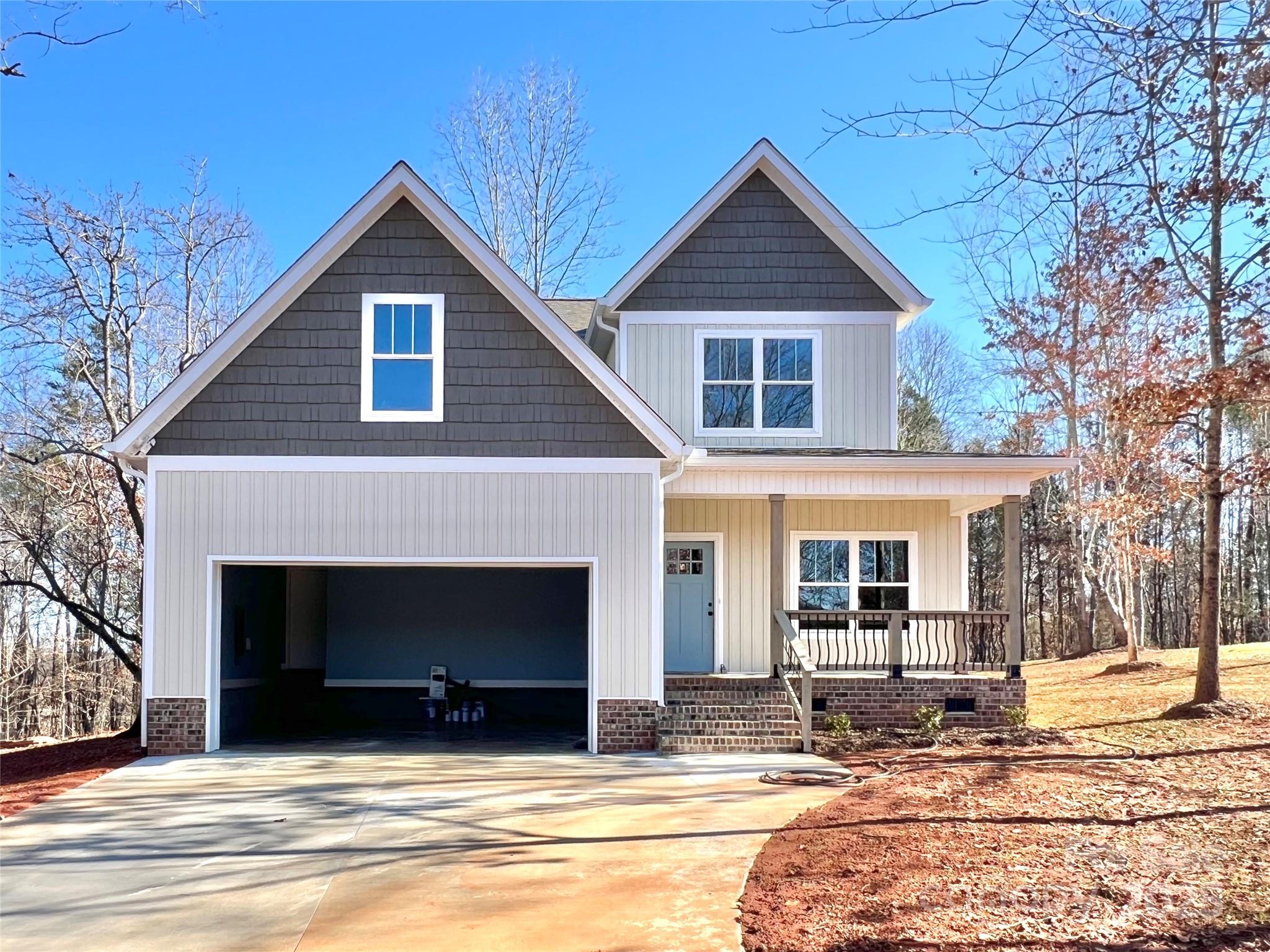 122 Arrowood Lane Harmony, NC 28634 - Photo 2 of 47 a view of a house with a yard and large tree