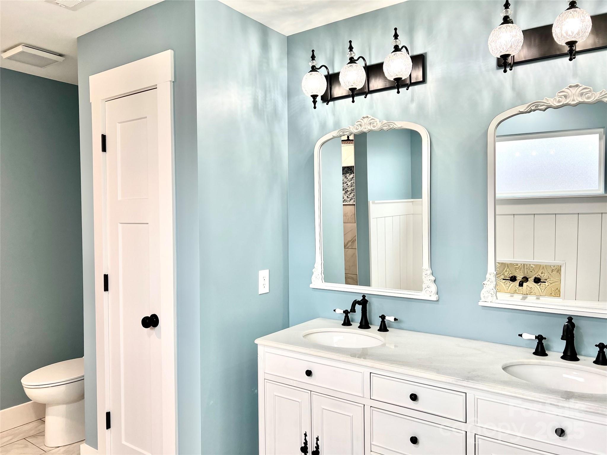 122 Arrowood Lane Harmony, NC 28634 - Photo 23 of 47 a bathroom with a double vanity sink mirror and toilet