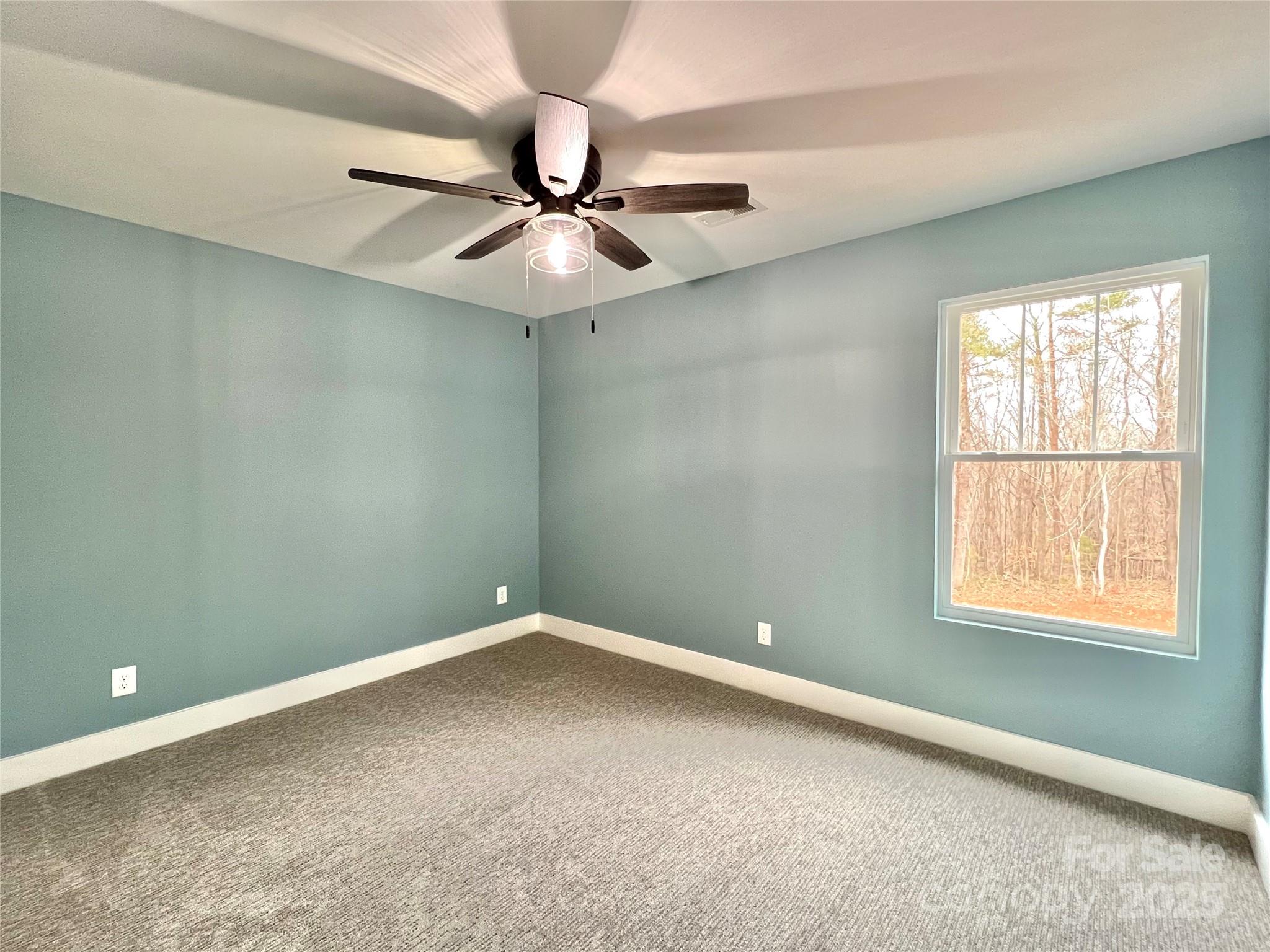122 Arrowood Lane Harmony, NC 28634 - Photo 27 of 47 an empty room with a window and a fan