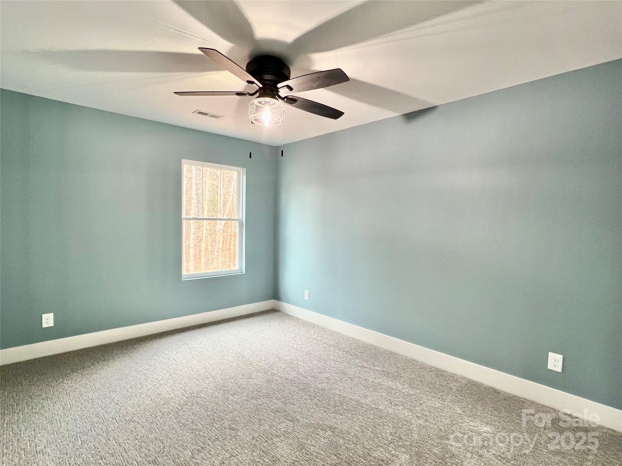 122 Arrowood Lane Harmony, NC 28634 - Photo 29 of 47 an empty room with a window and a fan