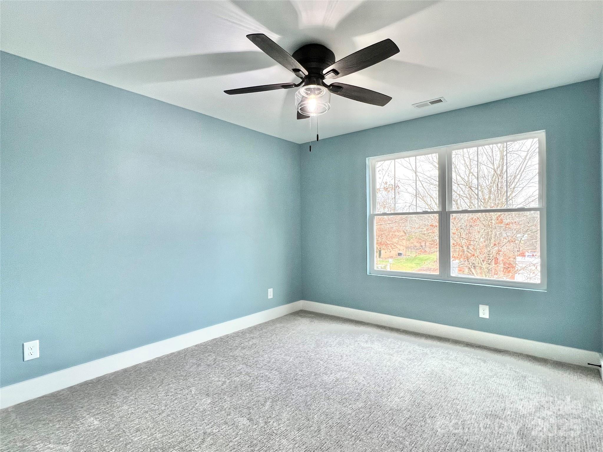 122 Arrowood Lane Harmony, NC 28634 - Photo 31 of 47 an empty room with a window and a fan