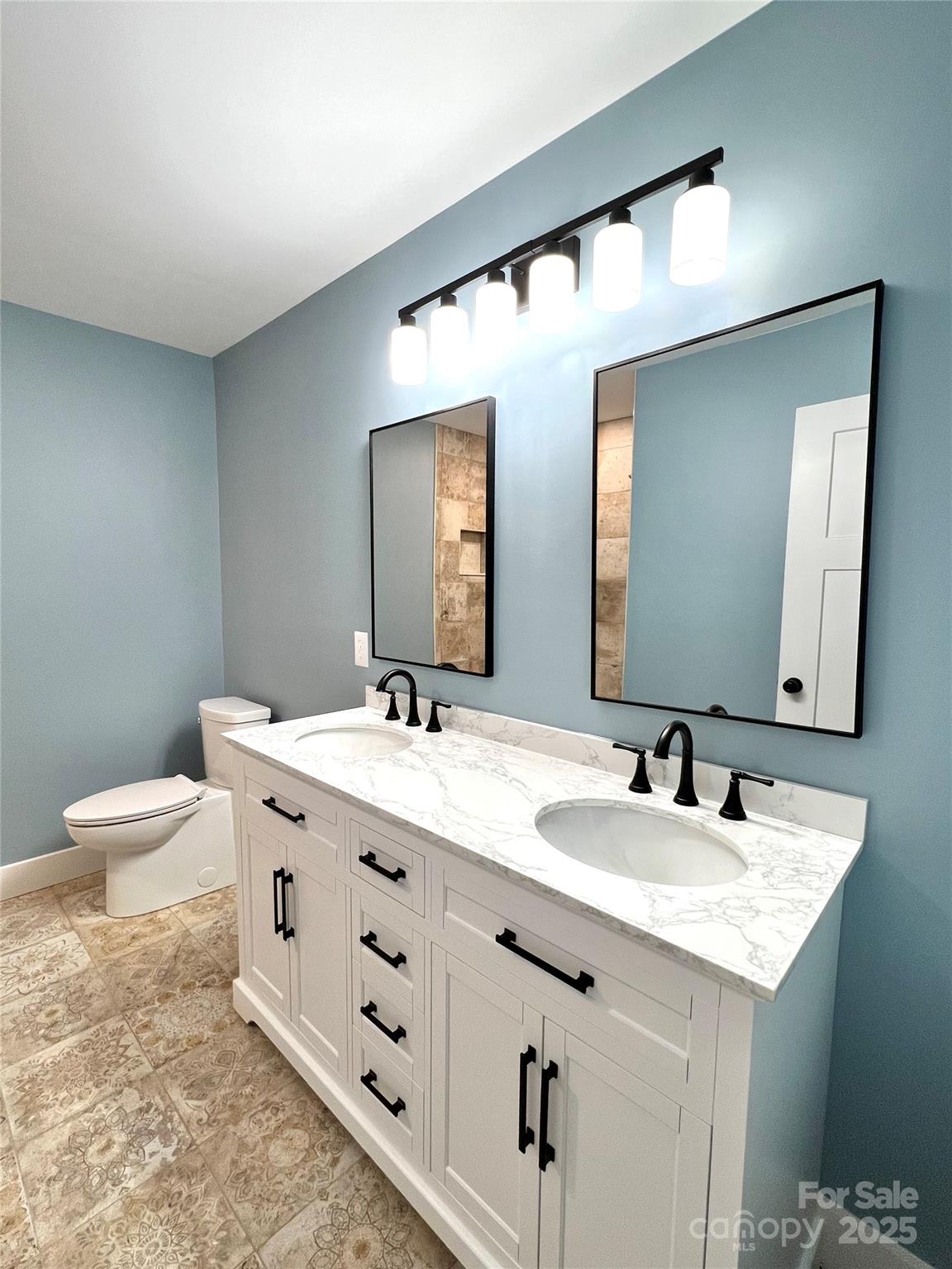 122 Arrowood Lane Harmony, NC 28634 - Photo 33 of 47 a bathroom with a double vanity sink and a mirror