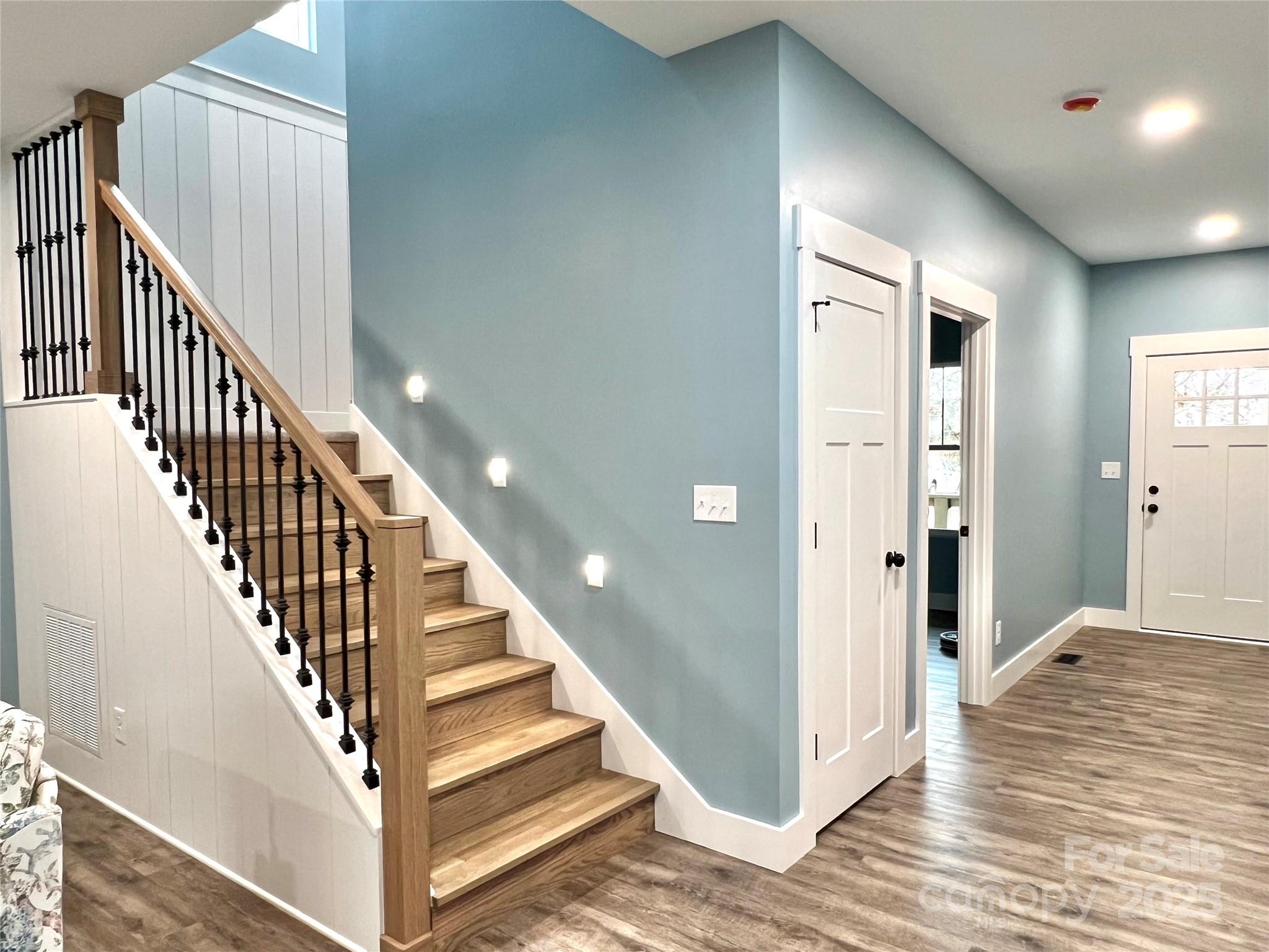 122 Arrowood Lane Harmony, NC 28634 - Photo 36 of 47 a view of a hallway with wooden floor and staircase