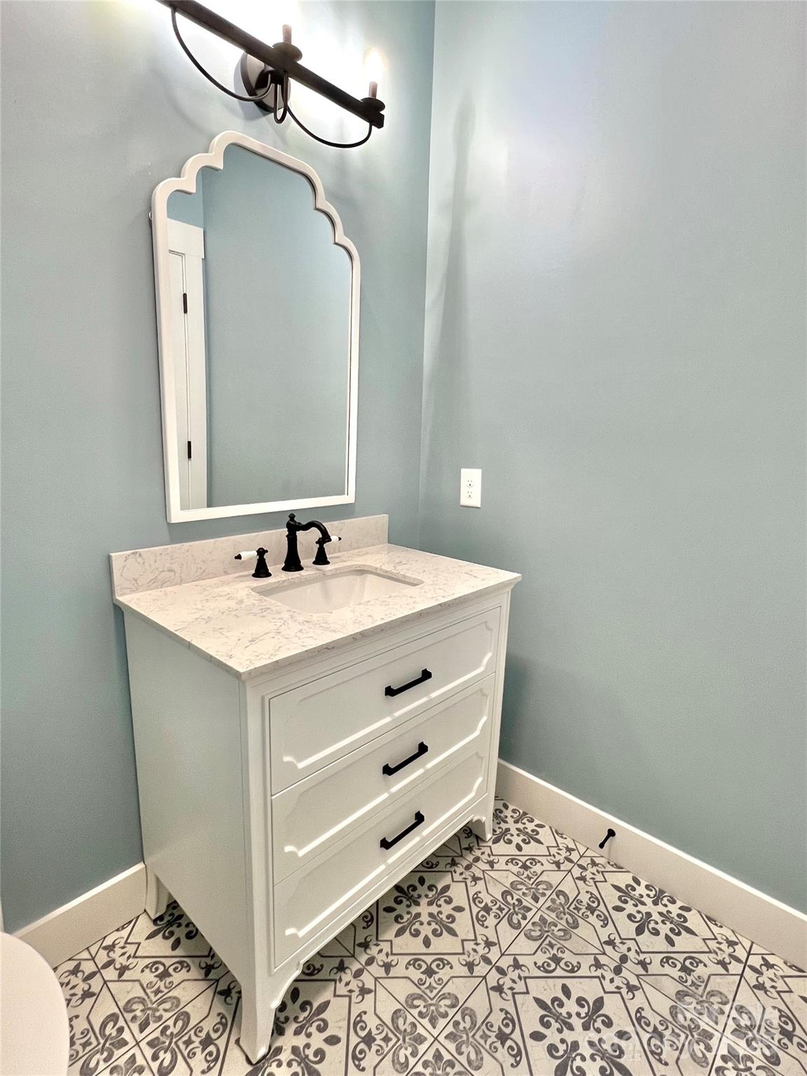 122 Arrowood Lane Harmony, NC 28634 - Photo 38 of 47 a bathroom with a sink a vanity and a mirror