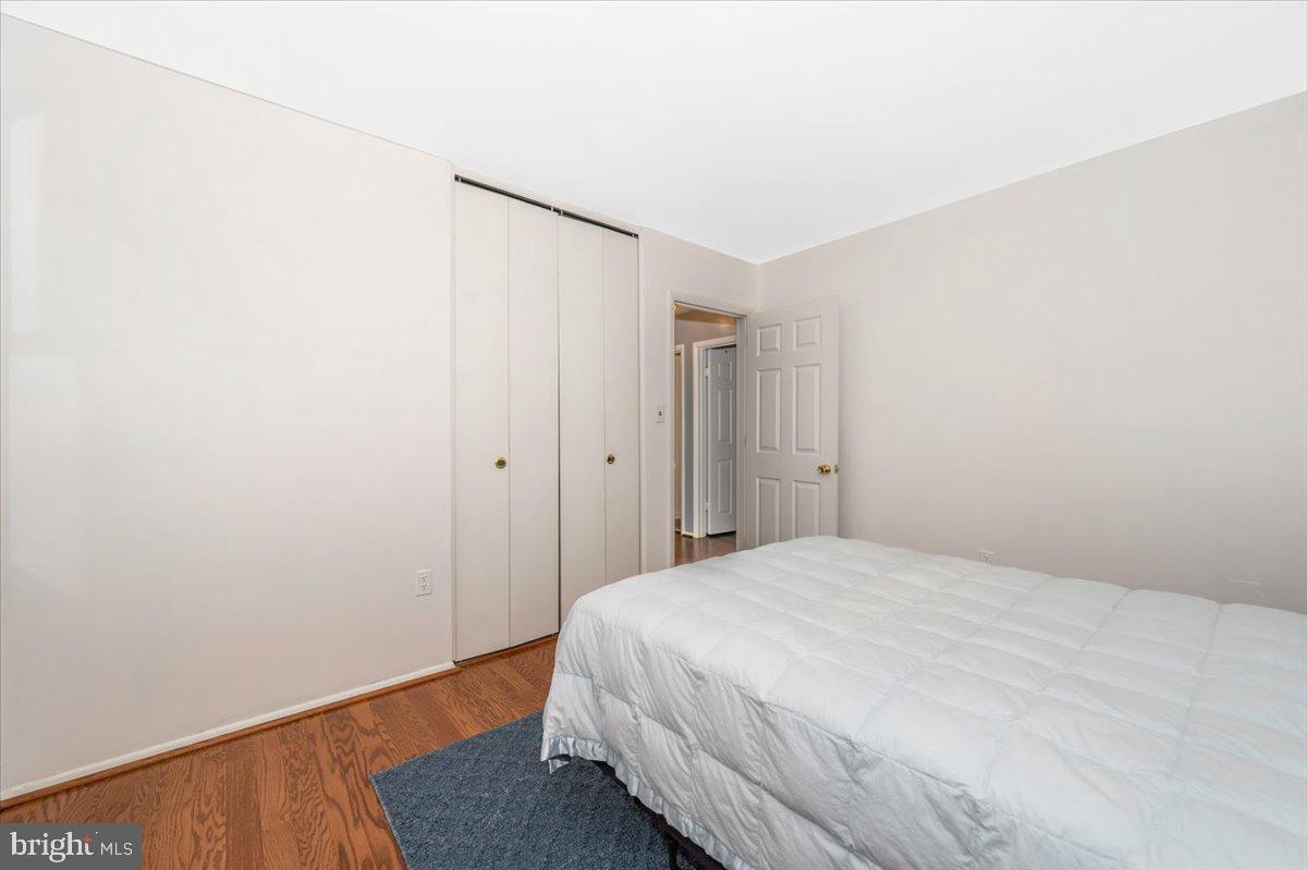 17400 Hughes Road Poolesville, MD 20837 - Photo 42 of 101 a bedroom with a bed and wooden floor