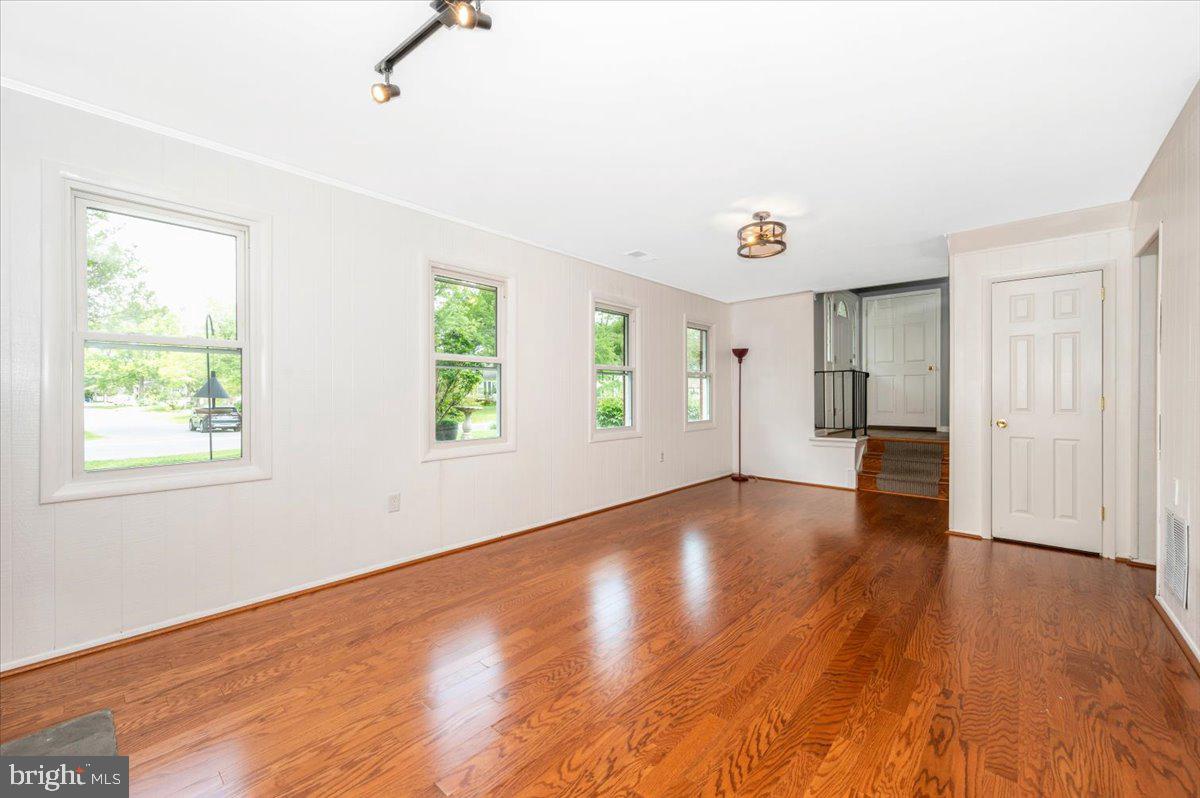 17400 Hughes Road Poolesville, MD 20837 - Photo 53 of 101 an empty room with wooden floor and windows