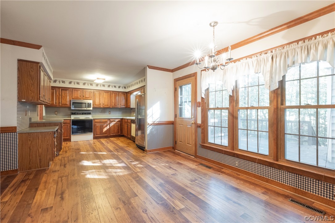341 Rossmere Drive Midlothian, VA 23114 - Photo 10 of 35 a view of a kitchen with kitchen island wooden floors center island and stainless steel appliances