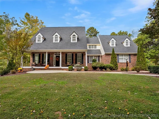 a front view of a house with swimming pool having outdoor seating