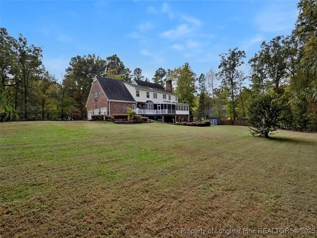 a view of a house with backyard sitting area and garden