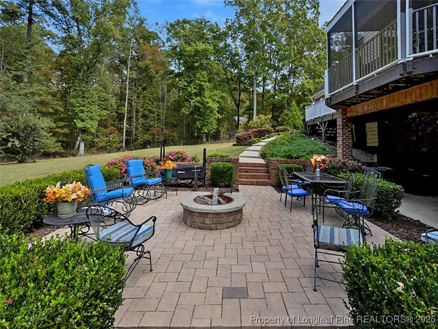 a large kitchen with kitchen island a large counter top space a sink stainless steel appliances and cabinets