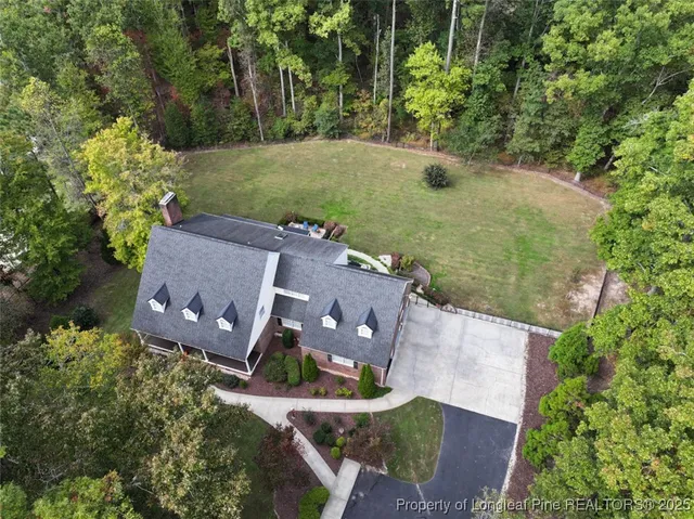 an aerial view of a house with a garden and yard