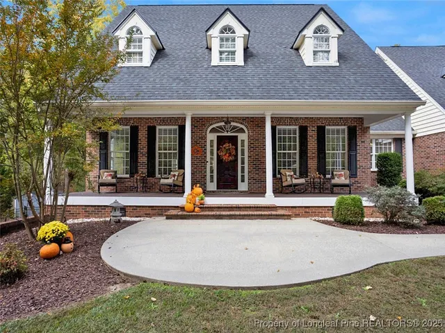 a balcony with wooden floor and outdoor seating